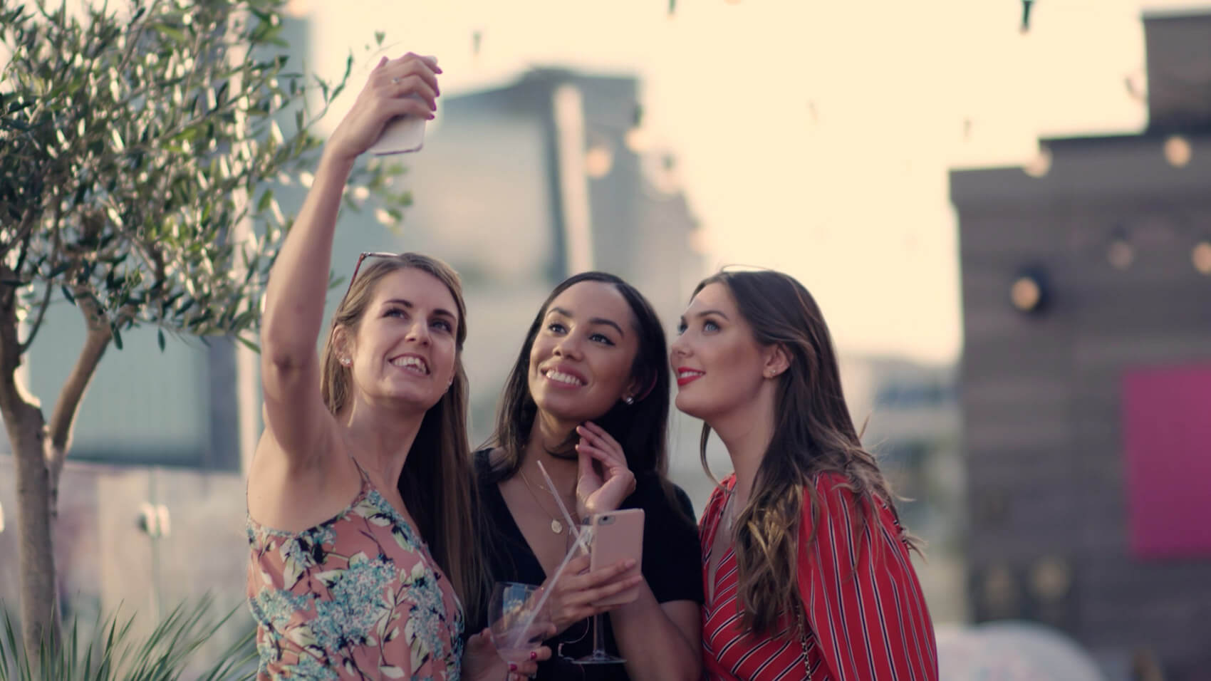 Three women pose for a selfie in an event videos example