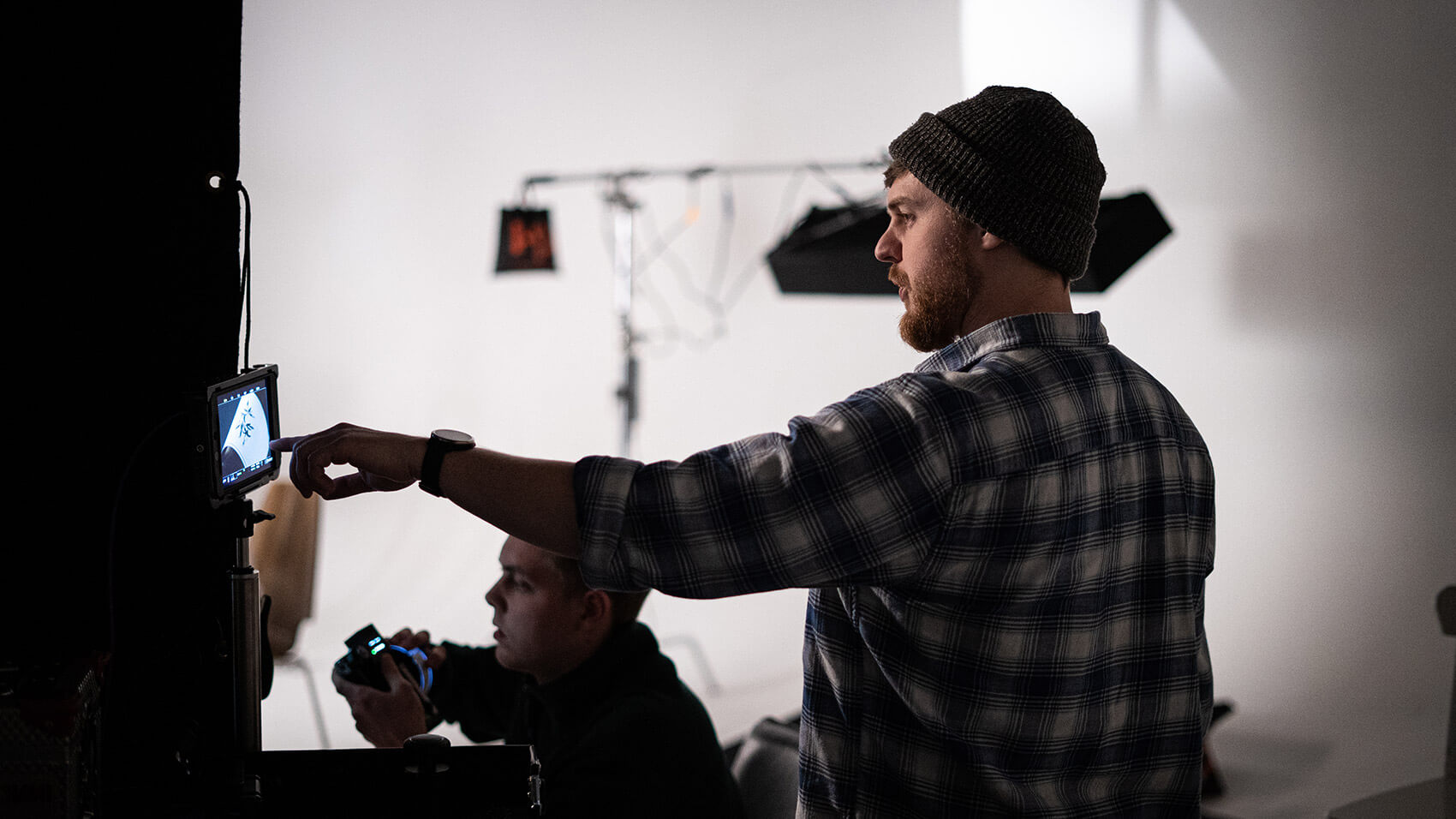 Mark Lunt directing a studio shoot, looking at a video monitor