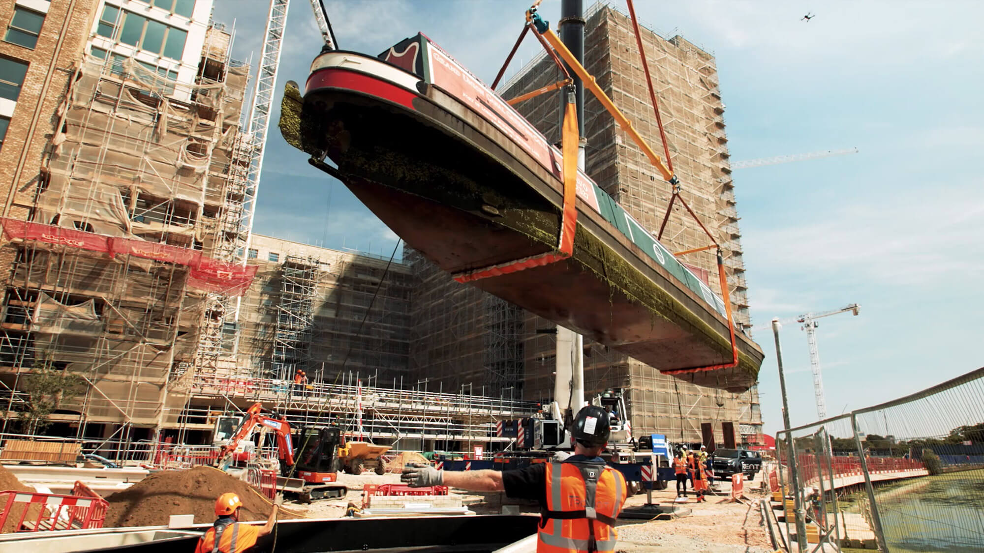 A narrowboat being lifted by crane into a canal in a video filmed by Rise Media