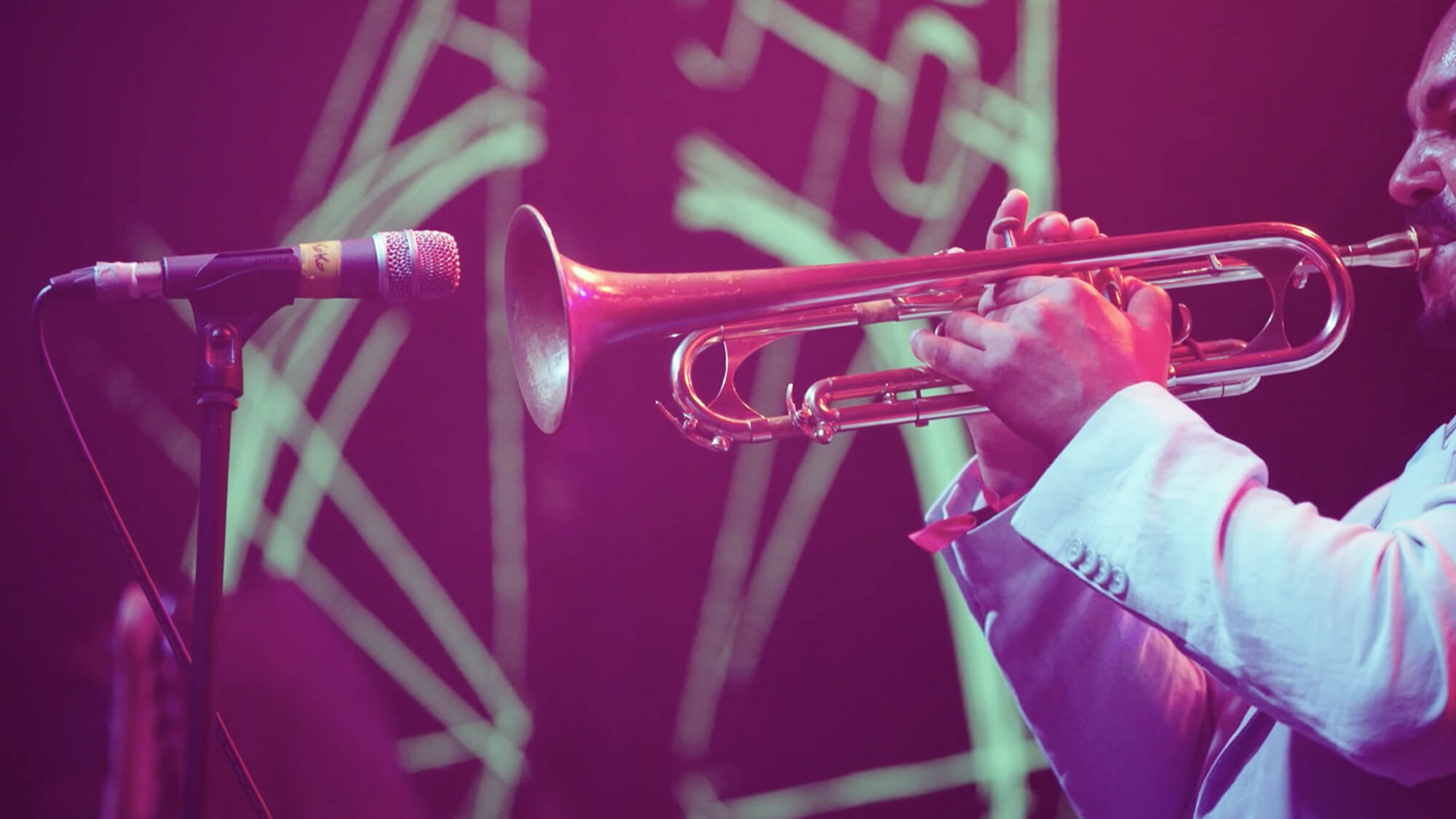 Still image of a trumpet player on stage at an Audemars Piguet music event, filmed by Rise Media