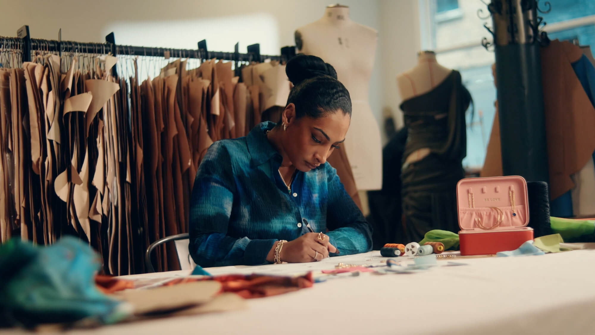 Designer Priya Ahluwalia working at a desk
