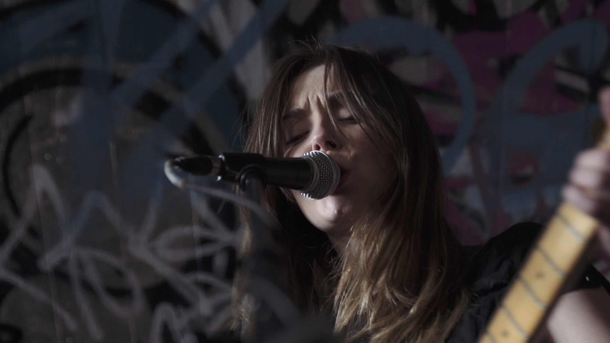 A close-up shot of the Honeyblood vocalist performing during the Dr Martens Flash Tour, from the Rise Media case studies archive