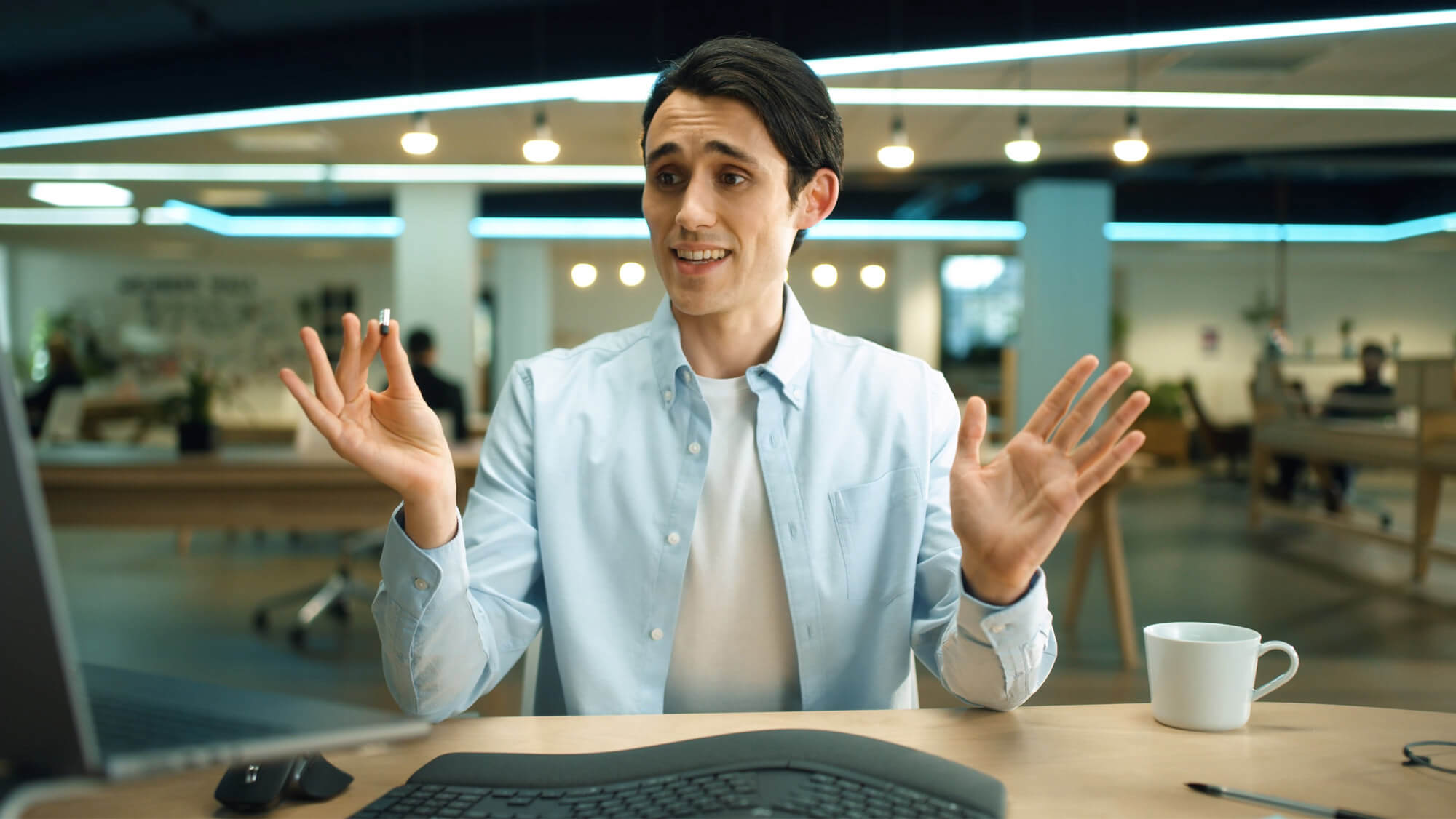 An IT director holds up a Logi Bolt in our Logitech Ping ad, from the Rise Media case studies archive