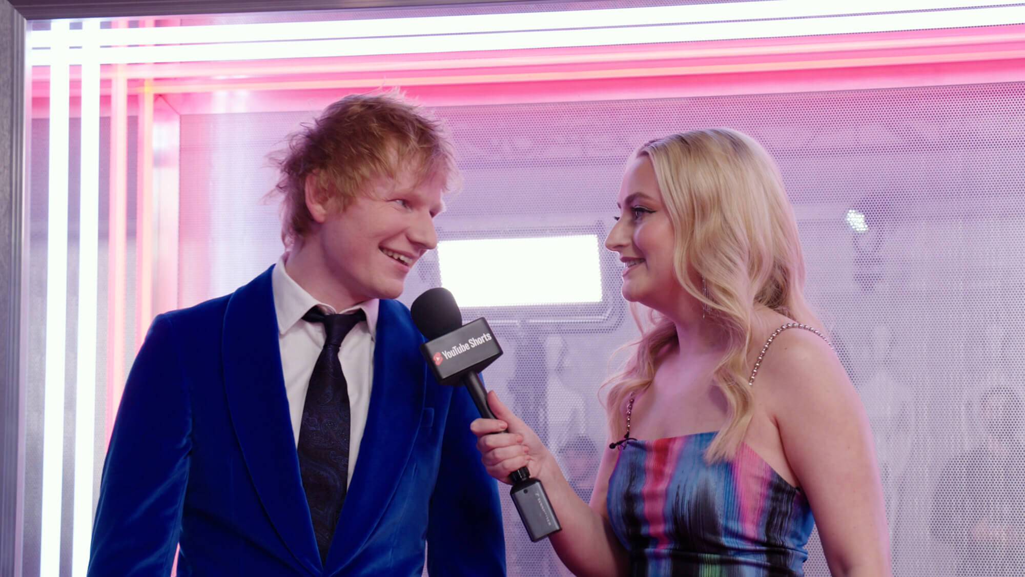 Presenter Amelia Dimoldenberg with a microphone interviews Ed Sheeran at The BRITS 2022, from the Rise Media case studies archive