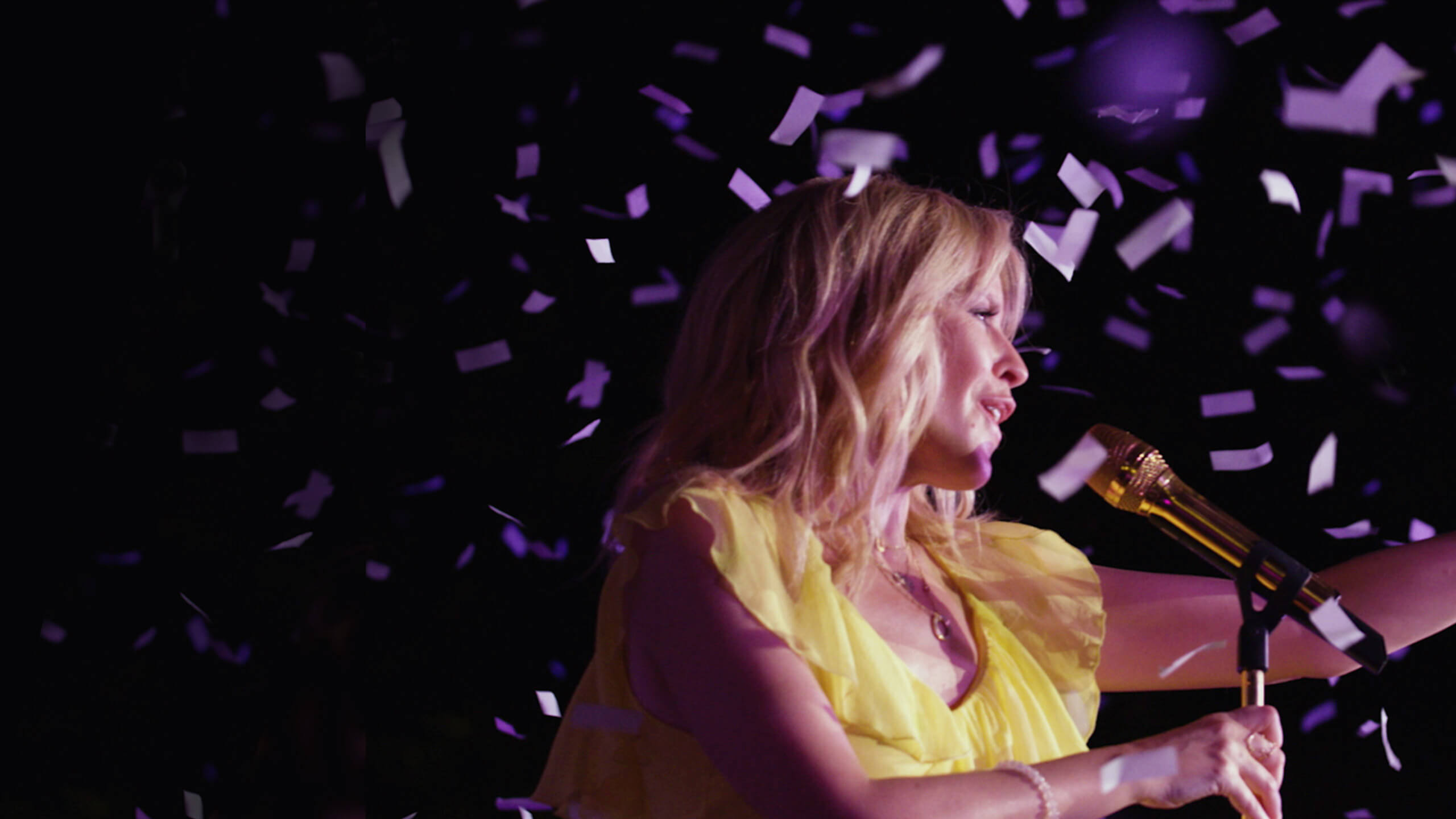 Kylie Minogue singing at night surrounded by confetti, from an event videos project for News UK